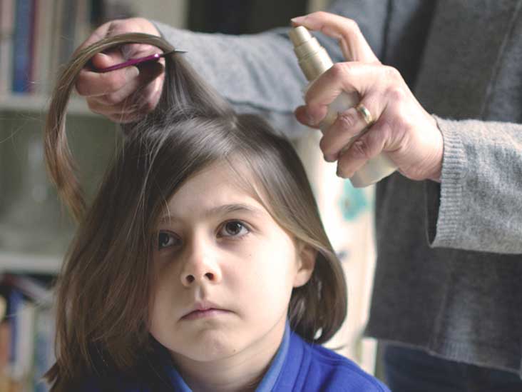 Girl getting peppermint oil sprayed in her hair